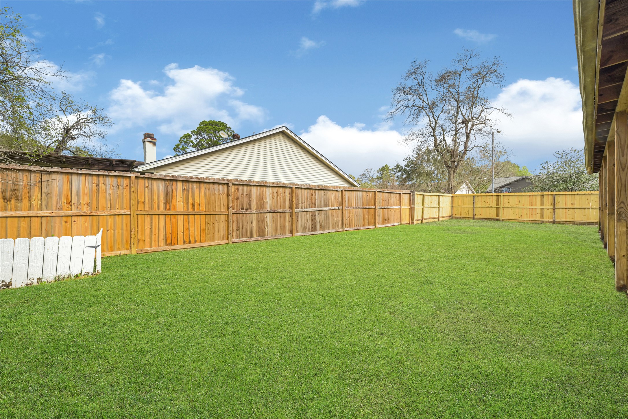 4102 Townes Forest Road Friendswood, TX 77546 - Photo 44 of 50 Wide backyard with open green space and privacy fencing.