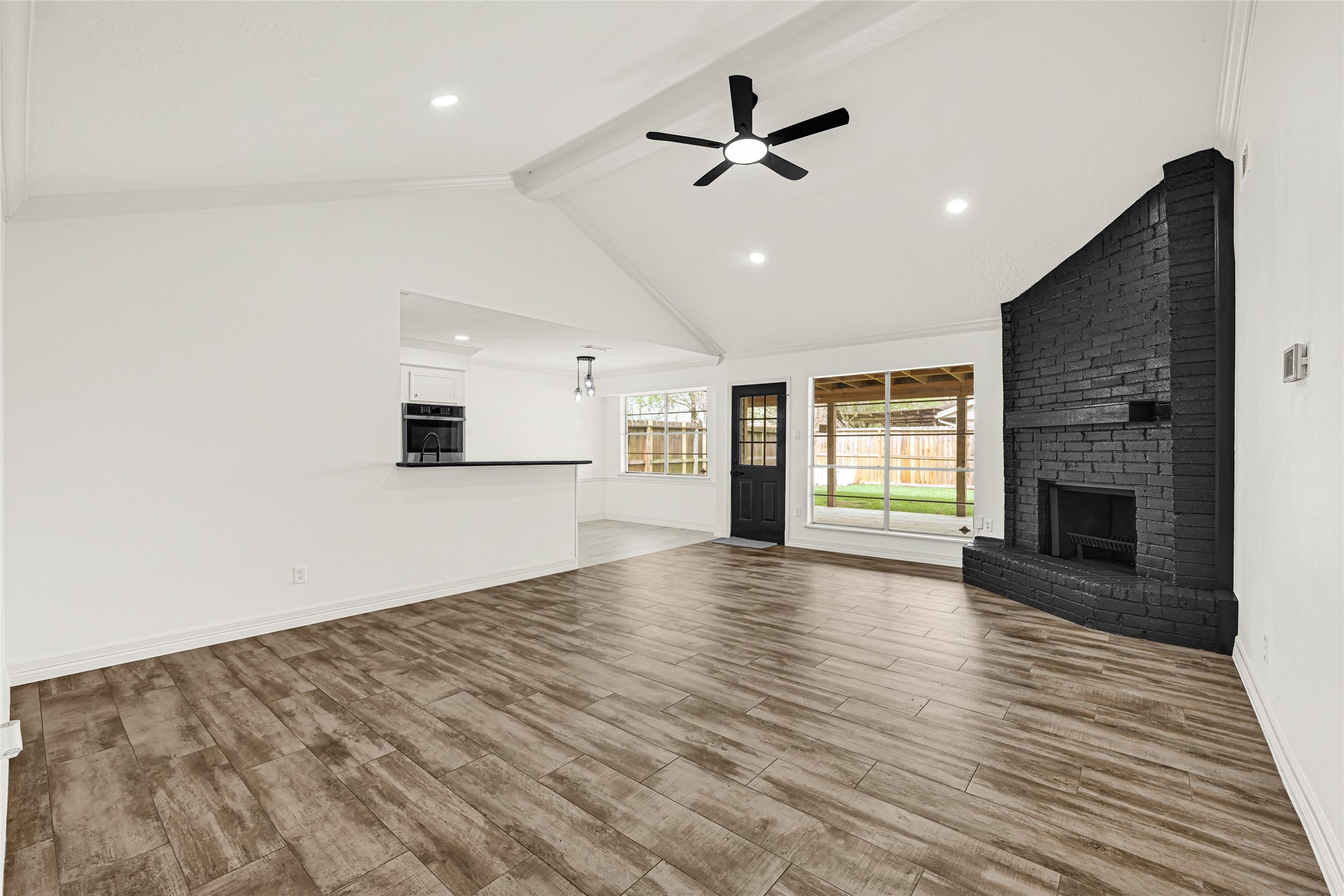 4102 Townes Forest Road Friendswood, TX 77546 - Photo 7 of 50 Large living space with updated flooring, modern ceiling fan, and an open feel ideal for everyday living.