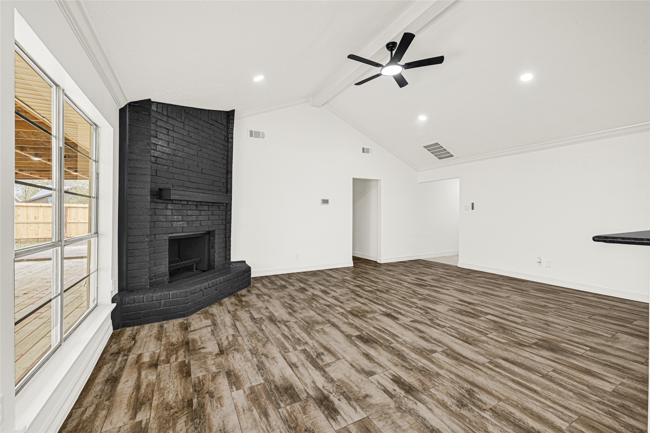 4102 Townes Forest Road Friendswood, TX 77546 - Photo 8 of 50 Light-filled living area with expansive windows and a stylish focal wall for added character.