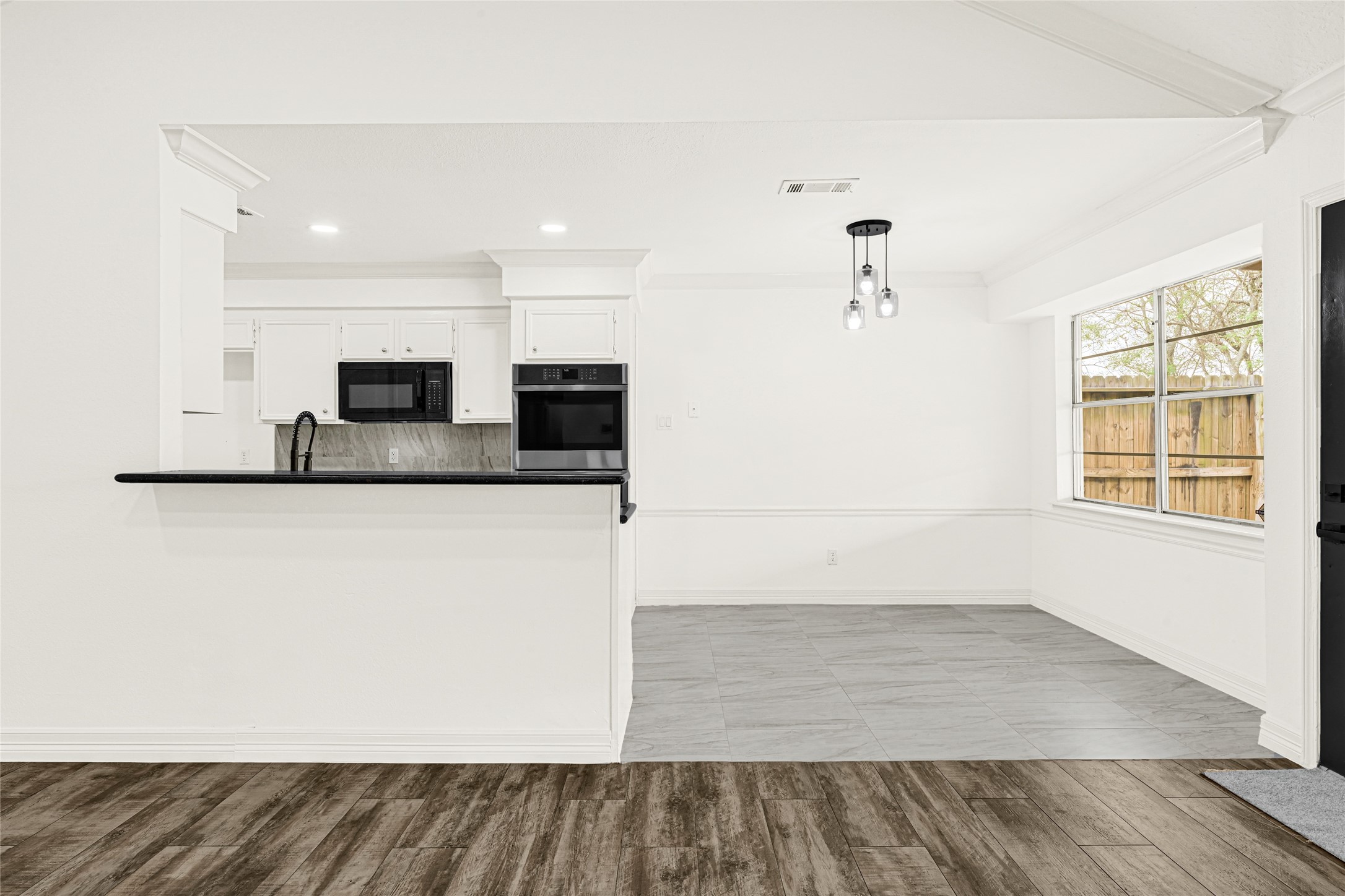 4102 Townes Forest Road Friendswood, TX 77546 - Photo 10 of 50 Seamless connection between living and kitchen areas, creating an ideal layout for gatherings.