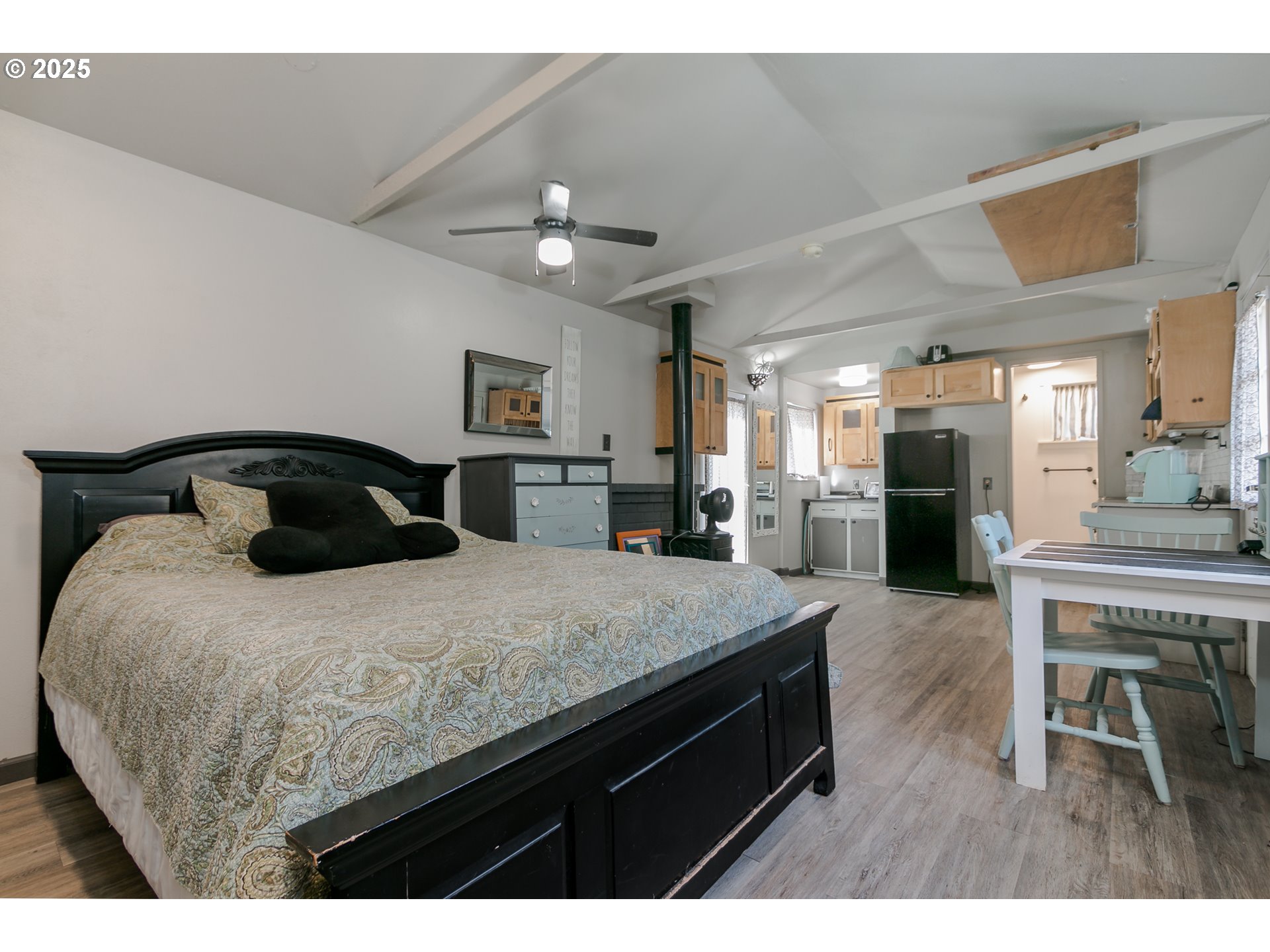 1755 East 43rd Avenue Eugene, OR 97405 - Photo 30 of 34 a bedroom with a bed a table and chair