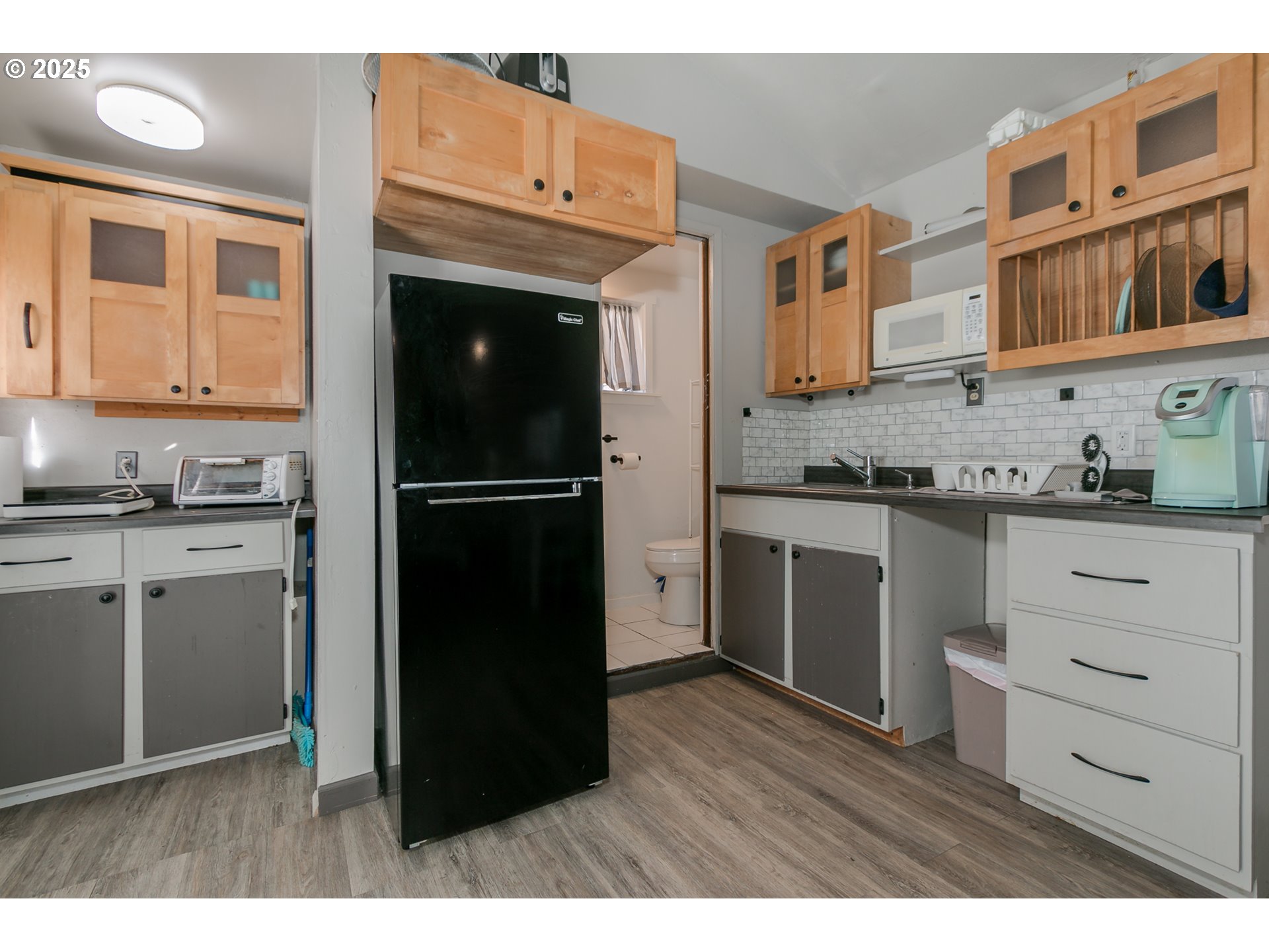 1755 East 43rd Avenue Eugene, OR 97405 - Photo 32 of 34 a kitchen with a refrigerator and a stove top oven