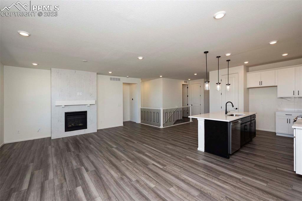 2120 Peachleaf Loop Castle Rock, CO 80108 - Photo 12 of 28 a view of a kitchen with a sink and a fireplace