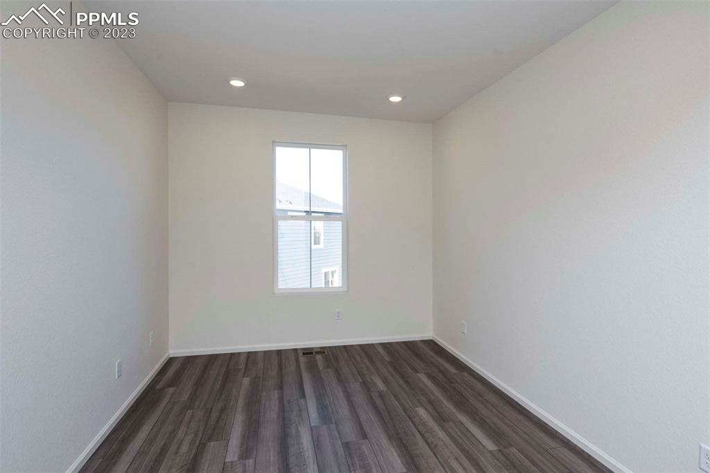 2120 Peachleaf Loop Castle Rock, CO 80108 - Photo 3 of 28 an empty room with wooden floor and windows