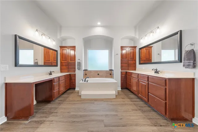 a bathroom with a double vanity sink mirror and toilet