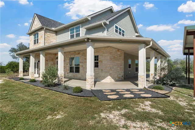 a kitchen with stainless steel appliances kitchen island granite countertop a stove a sink and a microwave