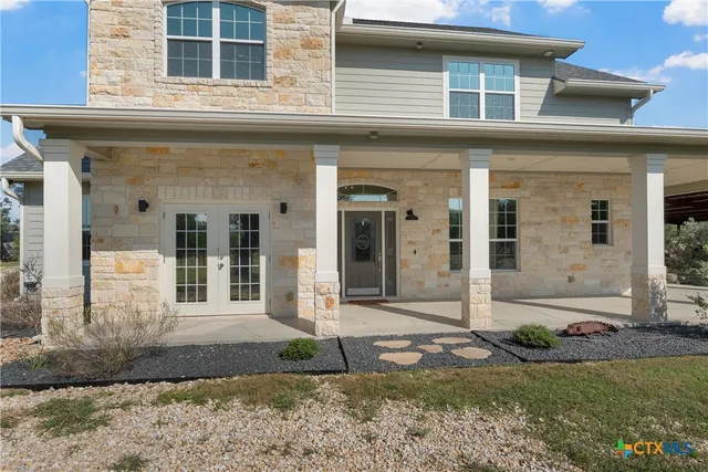 a kitchen with stainless steel appliances granite countertop white cabinets and a sink