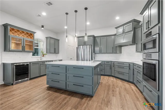 a living room with furniture flat screen tv and a large window