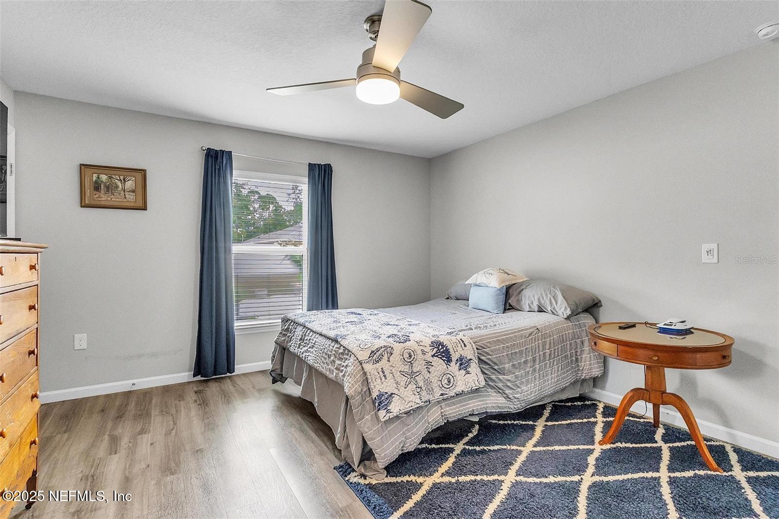 19 Ruth Drive Palm Coast, FL 32164 - Photo 9 of 23 a bedroom with a bed and a chandelier