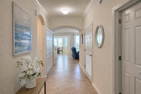 a kitchen with stainless steel appliances granite countertop a stove top oven a sink a dining table and chairs