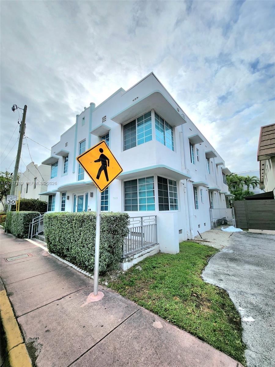 7936 Harding Avenue, Unit 6 Miami Beach, FL 33141 - Photo 1 of 12 a front view of a house with garden