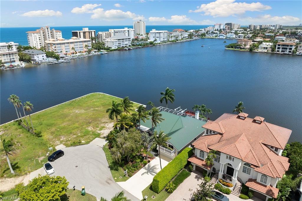283 Oak Avenue Naples, FL 34108 - Photo 1 of 39 an aerial view of a house with a lake view