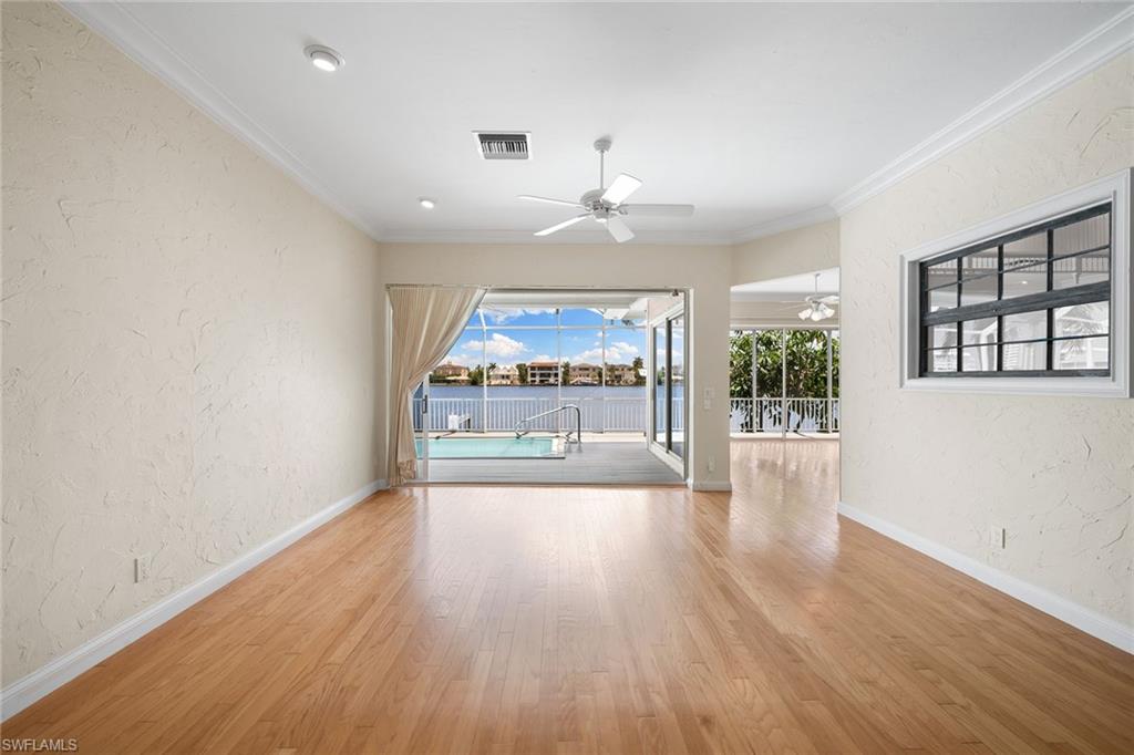 283 Oak Avenue Naples, FL 34108 - Photo 12 of 39 wooden floor in an empty room with a window