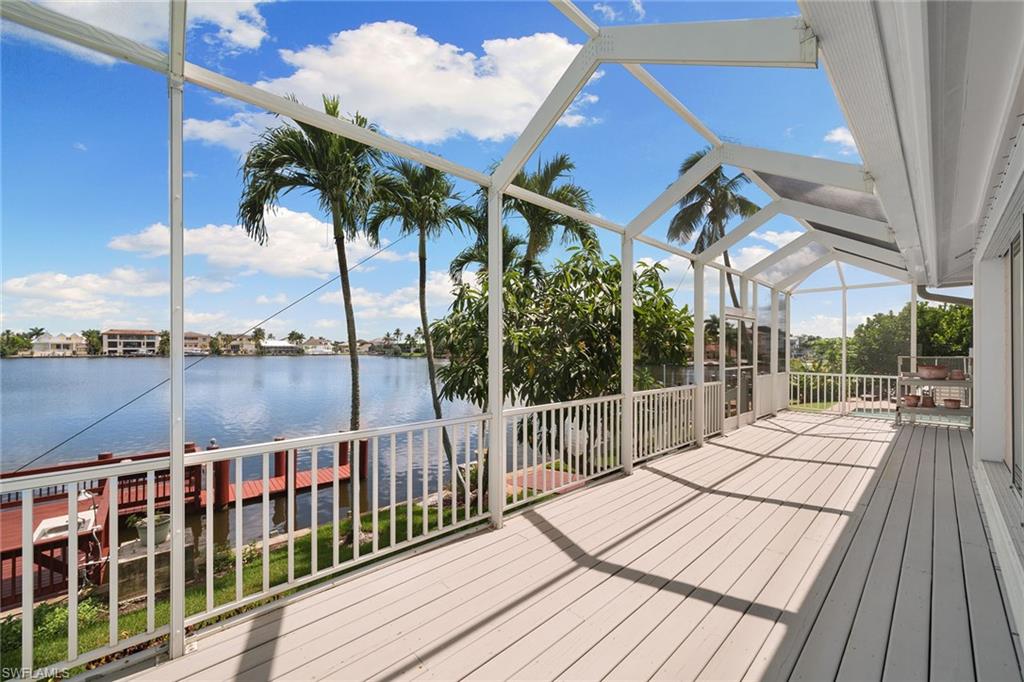 283 Oak Avenue Naples, FL 34108 - Photo 17 of 39 a view of balcony with wooden floor and fence