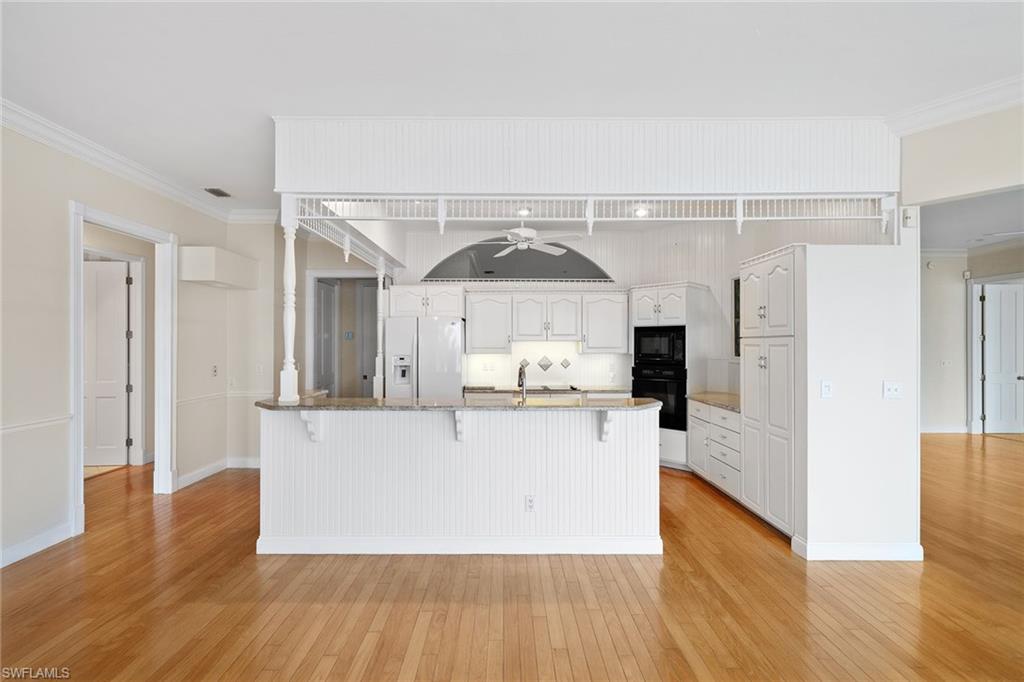 283 Oak Avenue Naples, FL 34108 - Photo 18 of 39 a view of a kitchen with wooden floor