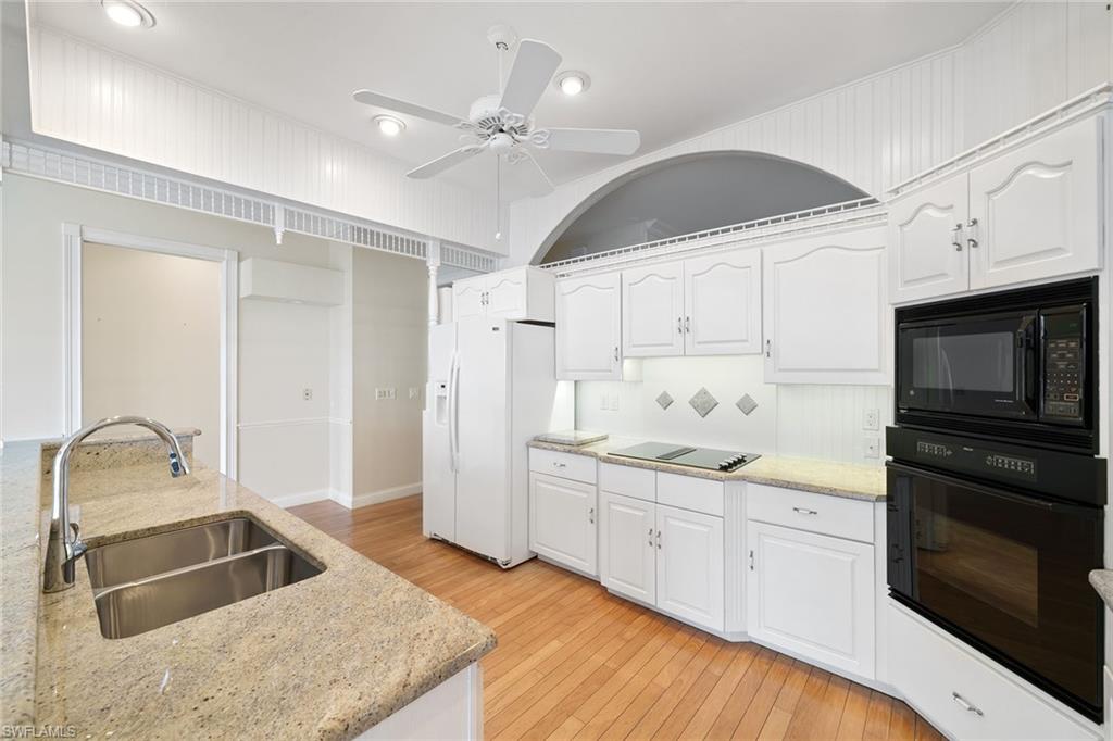 283 Oak Avenue Naples, FL 34108 - Photo 20 of 39 a kitchen with a sink appliances and cabinets