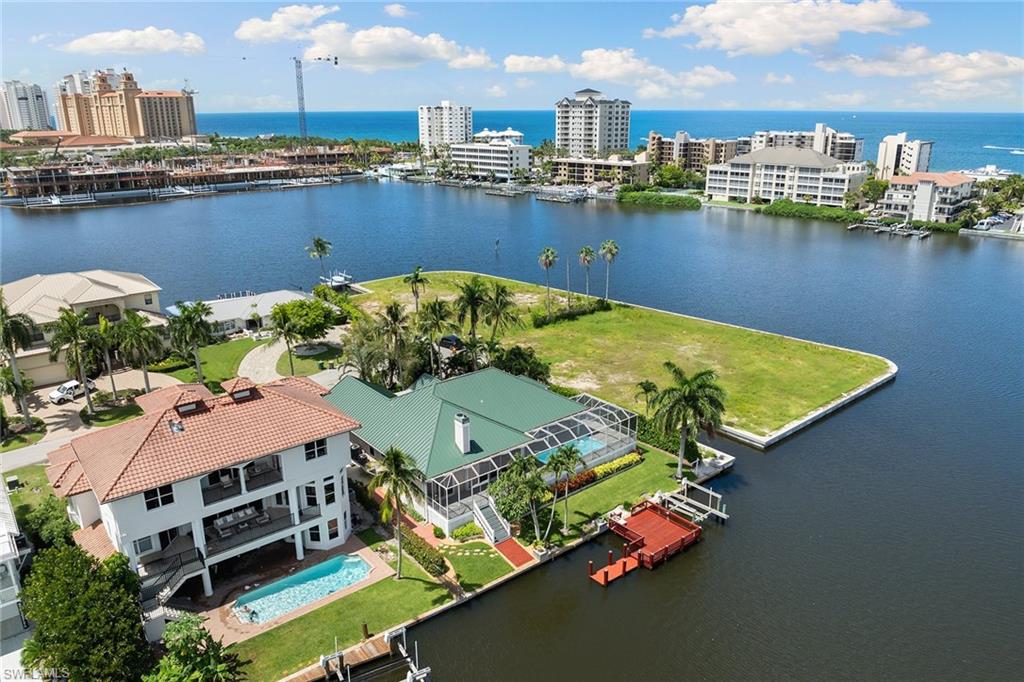 283 Oak Avenue Naples, FL 34108 - Photo 2 of 39 an aerial view of a house with a lake view