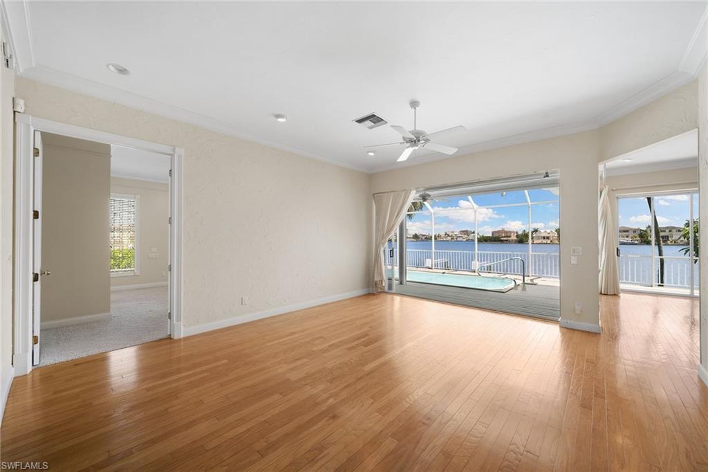 283 Oak Avenue Naples, FL 34108 - Photo 23 of 39 a view of an empty room with wooden floor and a window