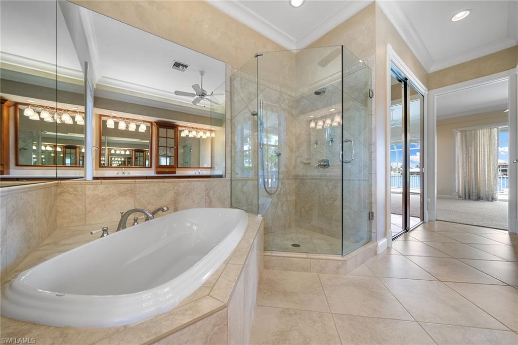 283 Oak Avenue Naples, FL 34108 - Photo 27 of 39 a bathroom with a tub a shower and sink