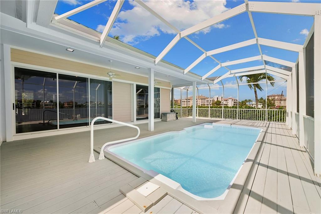 283 Oak Avenue Naples, FL 34108 - Photo 28 of 39 a view of a patio with a table and chairs