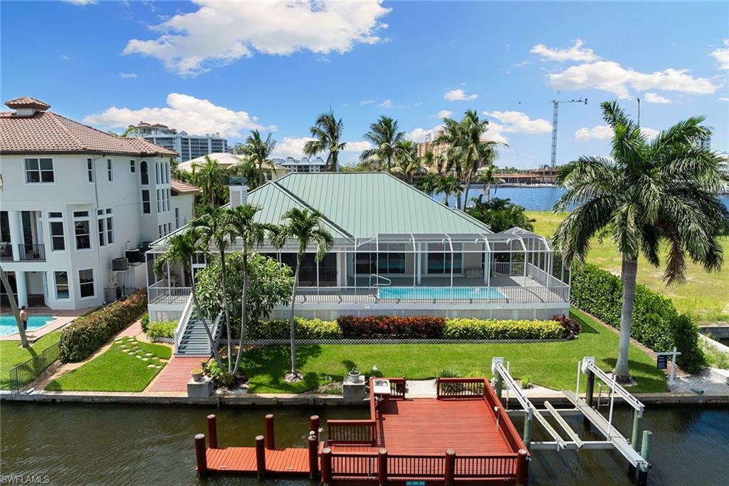 283 Oak Avenue Naples, FL 34108 - Photo 3 of 39 an aerial view of a house with swimming pool garden and lake view