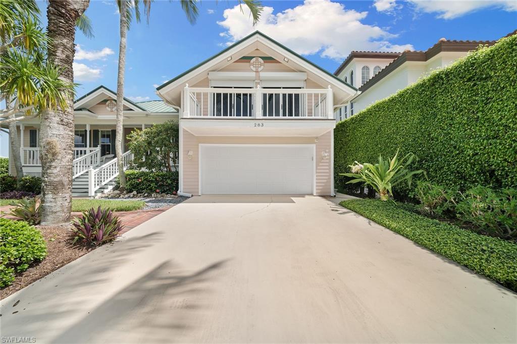 283 Oak Avenue Naples, FL 34108 - Photo 35 of 39 a front view of a house with a yard and trees