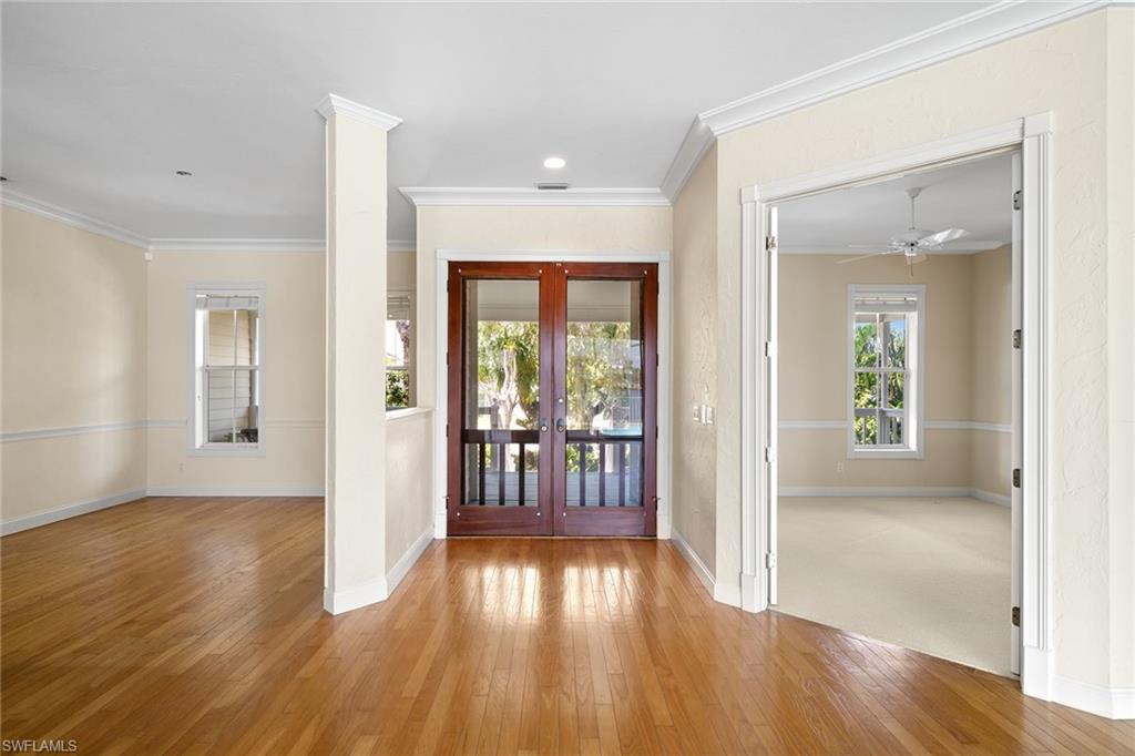 283 Oak Avenue Naples, FL 34108 - Photo 8 of 39 wooden floor in an empty room with a window