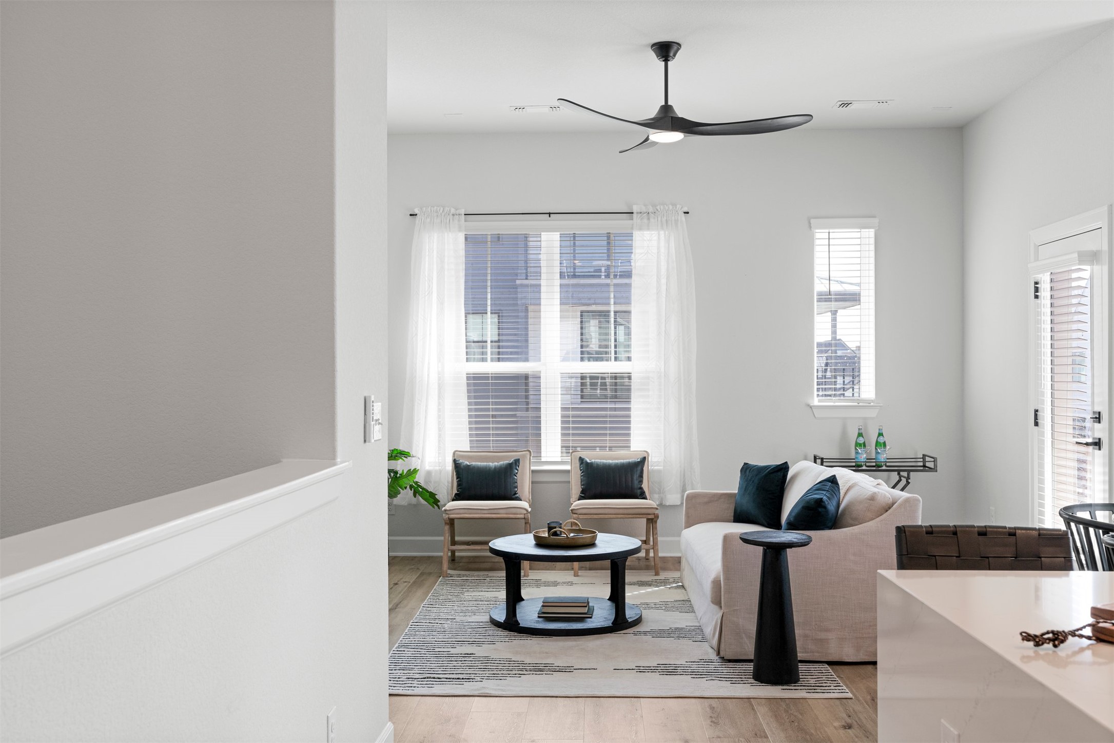 3900 Taniguchi Street Austin, TX 78723 - Photo 15 of 39 The open living, kitchen, and dining space feels like one continuous hangout zone, where conversations drift easily from the sofa to the island to the table without anyone ever feeling cut off from the action.