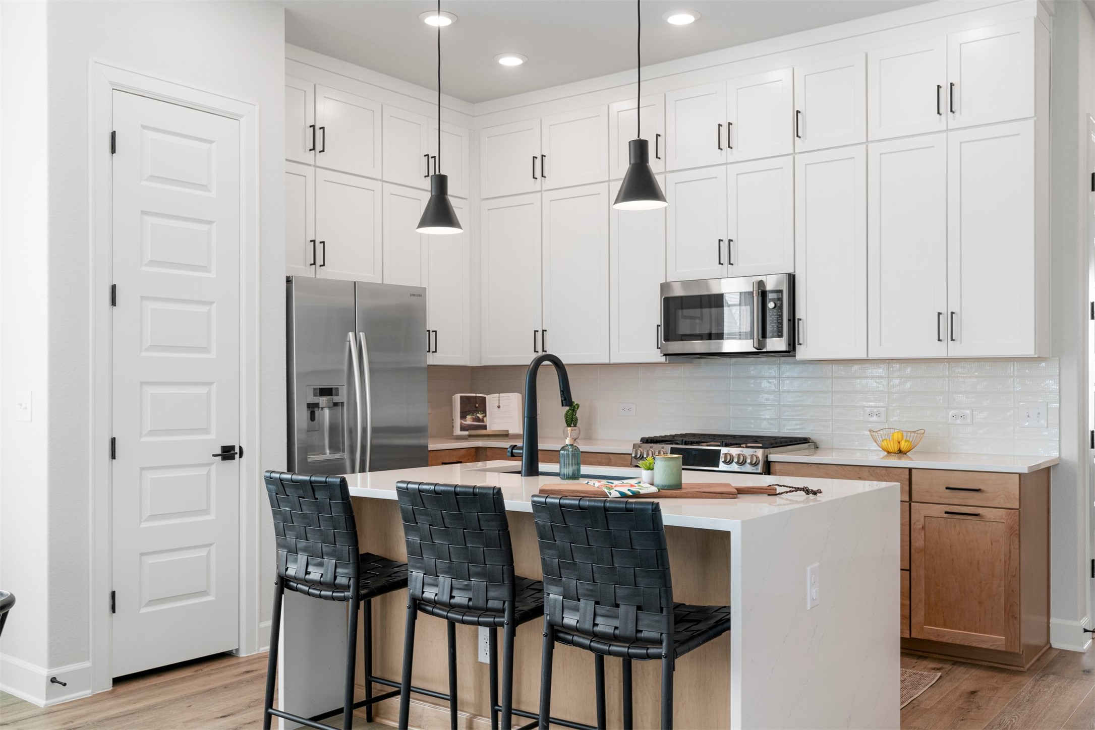3900 Taniguchi Street Austin, TX 78723 - Photo 20 of 39 From shaker cabinetry that reaches all the way to the ceiling to the stainless appliances and center island with a waterfall quartz countertop, this kitchen has it all!