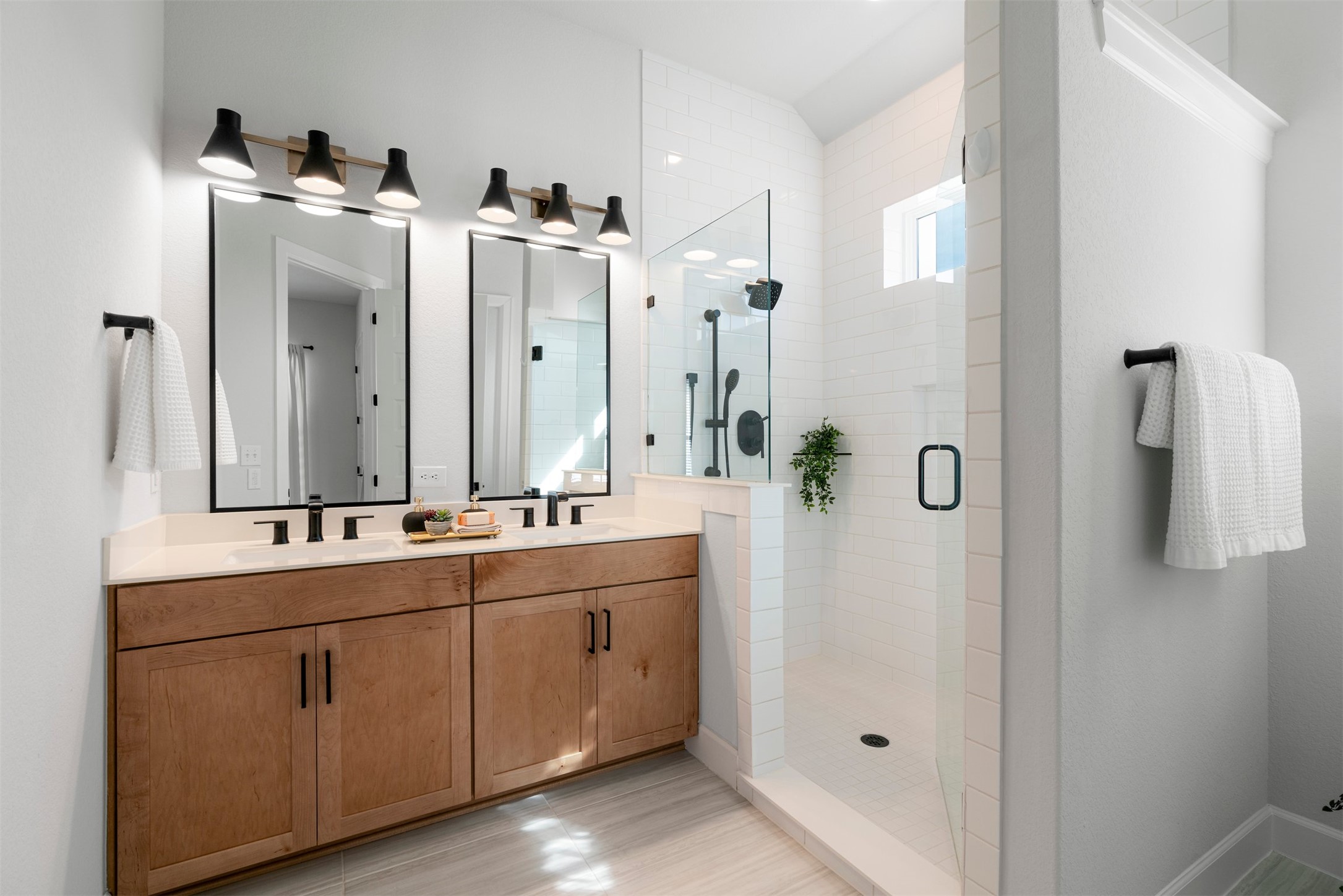 3900 Taniguchi Street Austin, TX 78723 - Photo 6 of 39 The ensuite bath brings everything together in one cohesive space, with dual vanities, a spacious walk-in shower, and a layout that feels open and easy to navigate from morning routines to winding down at night.