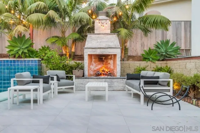 a view of a patio with dining table and chairs