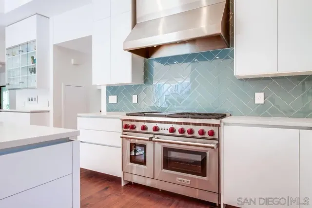 a stove top oven sitting inside of a kitchen