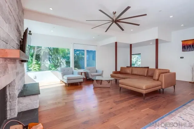 a living room with furniture and a large window