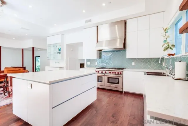 a kitchen with a stove a sink and a refrigerator