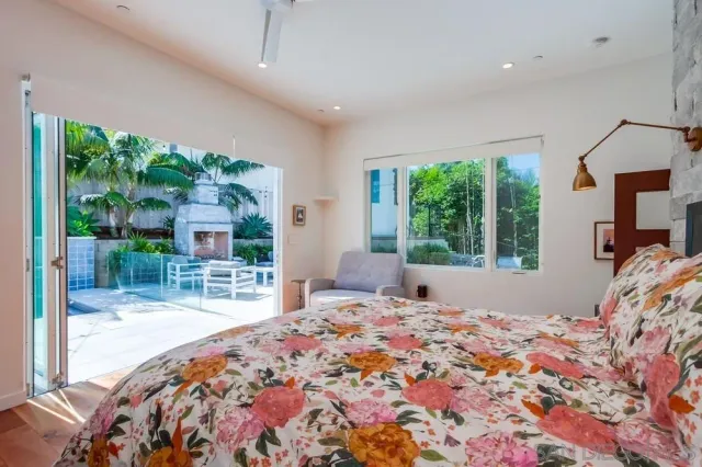 a bedroom with a bed and a large window