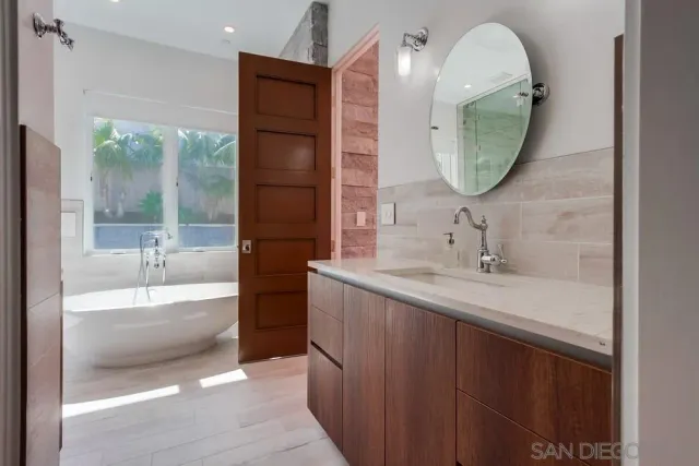 a en suite bathroom with a sink and a mirror