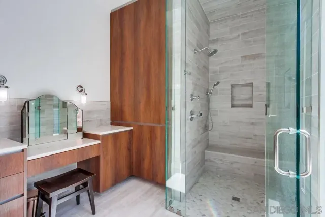 a bathroom with a sink a mirror and shower
