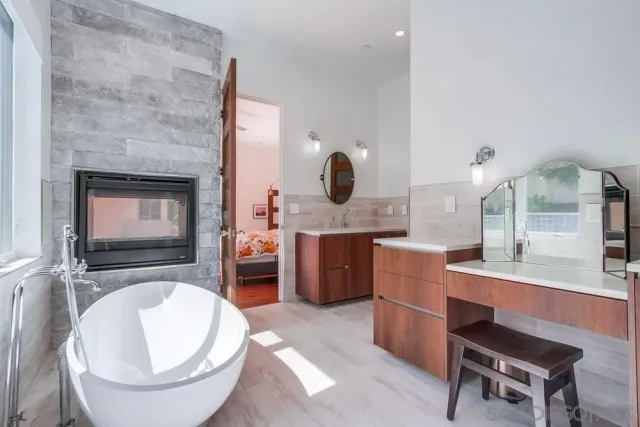 a room with a chair and a fireplace