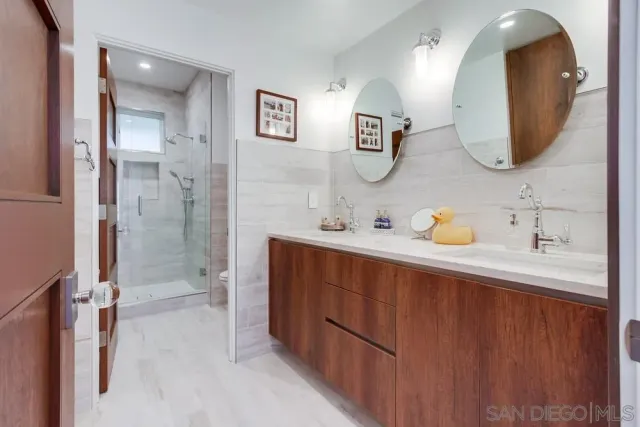 a spacious bathroom with a double vanity sink mirror and double