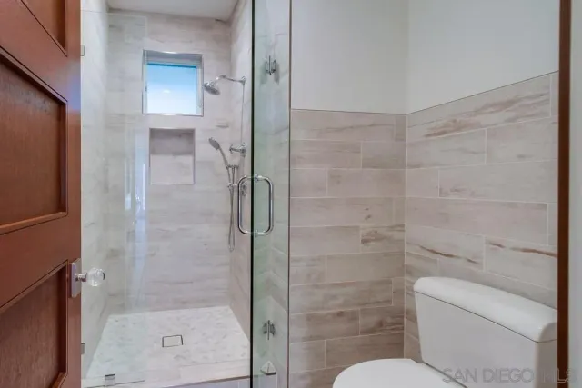 a bathroom with a shower and toilet