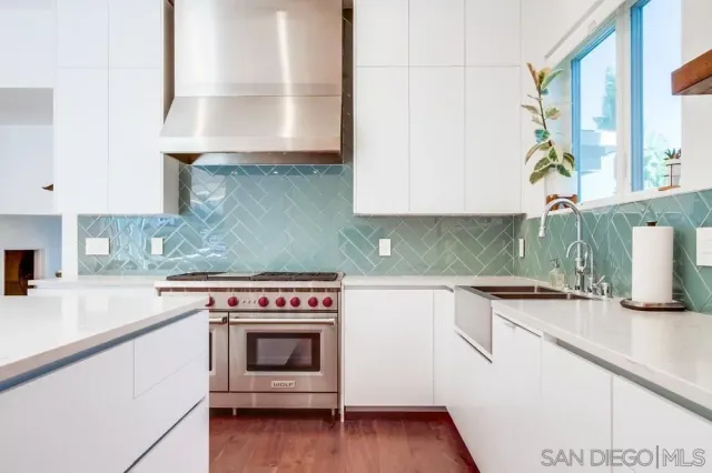 a kitchen with granite countertop a stove a sink and a granite counter tops