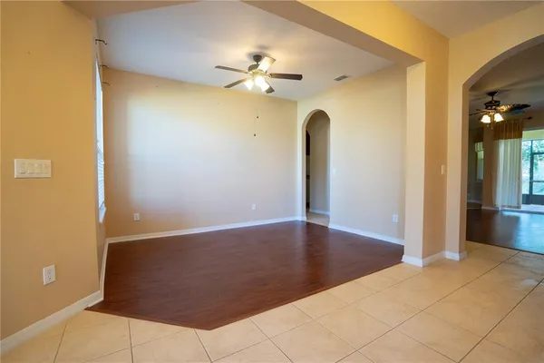 a view of a livingroom with a chandelier fan and a bathroom