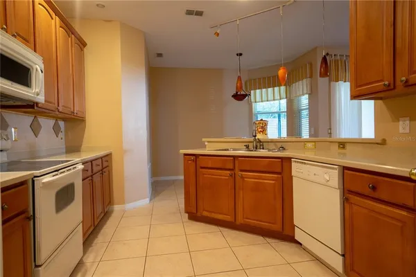 a kitchen with stainless steel appliances granite countertop a sink and a stove