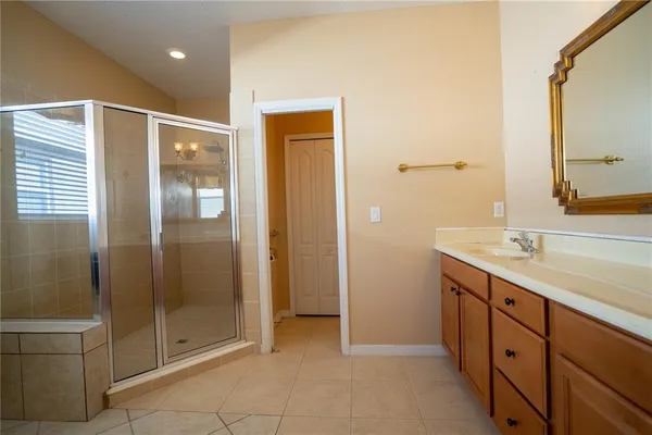 a bathroom with a shower sink and mirror