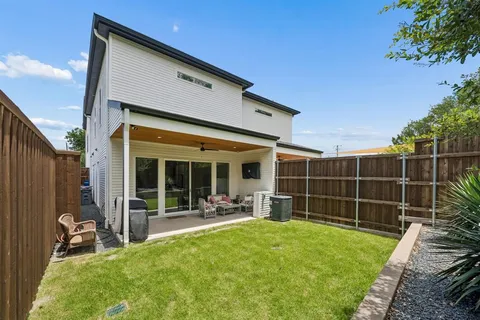 a view of a backyard with table and chairs and wooden fence
