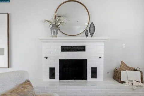 a bedroom with a bed a dresser and mirror