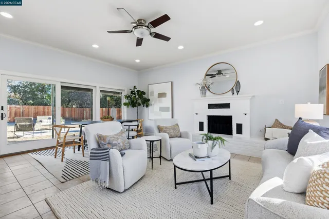 a living room with fireplace furniture and a large window