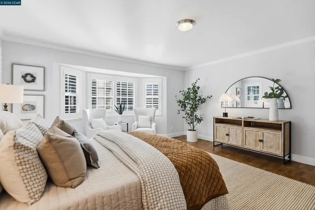 a bedroom with a bed a dresser and mirror