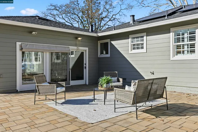 a outdoor space with a couch and chairs