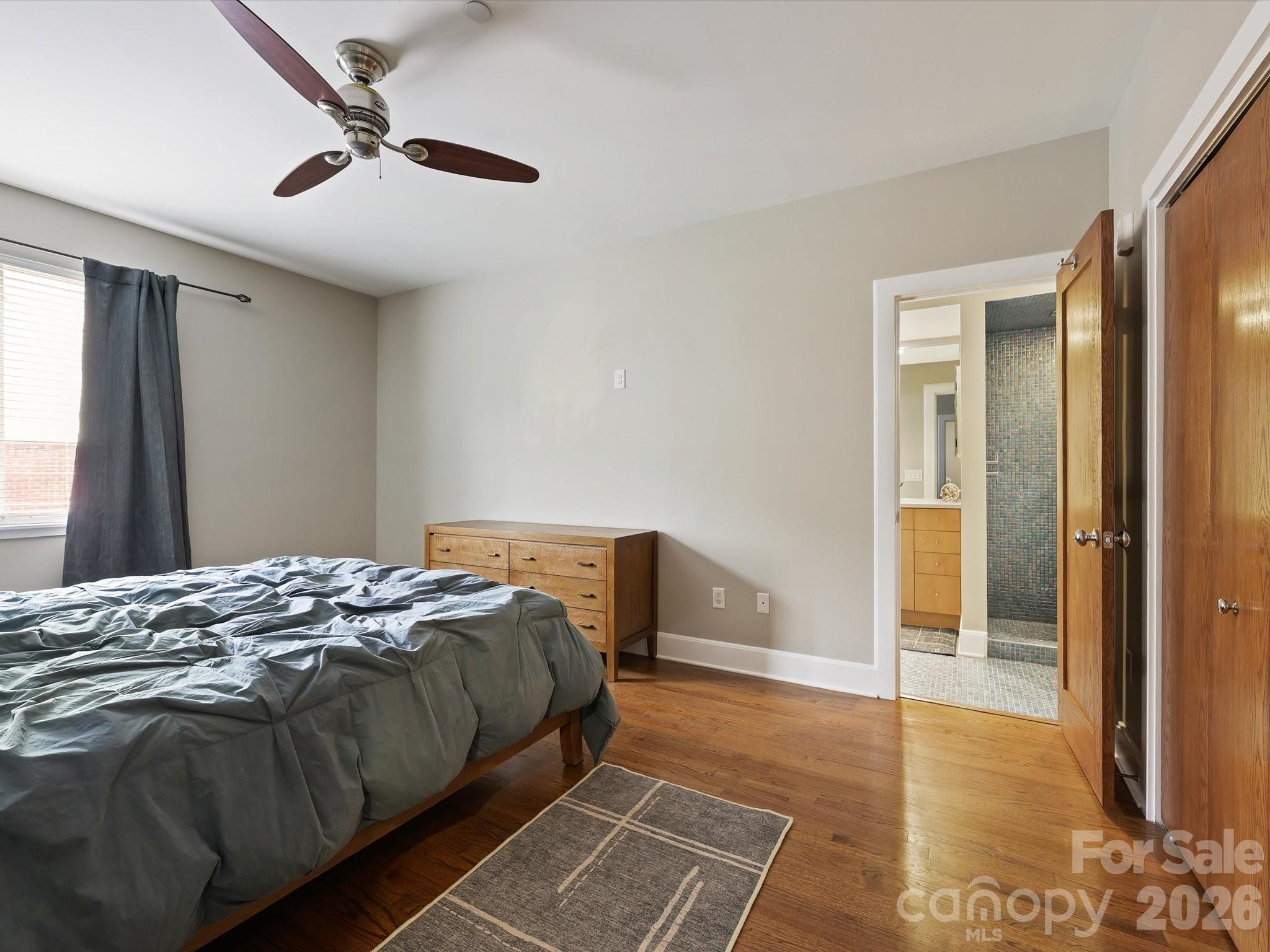 420 Queens Road Charlotte, NC 28207 - Photo 30 of 35 a bedroom with a bed and a window